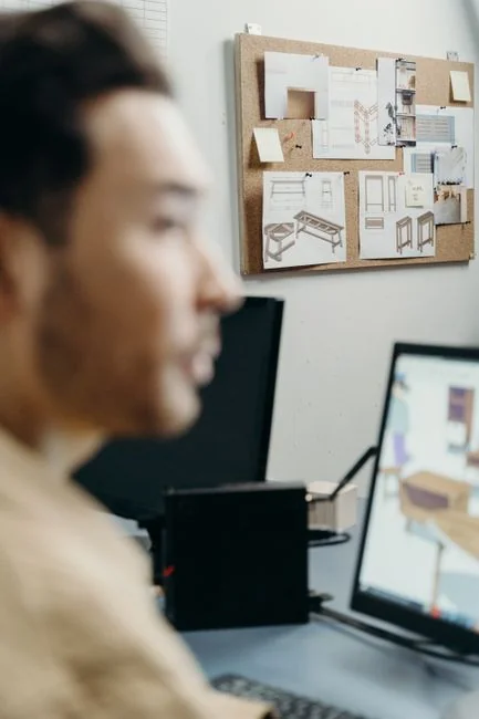 Two people browsing online clothing store on a laptop from above.
